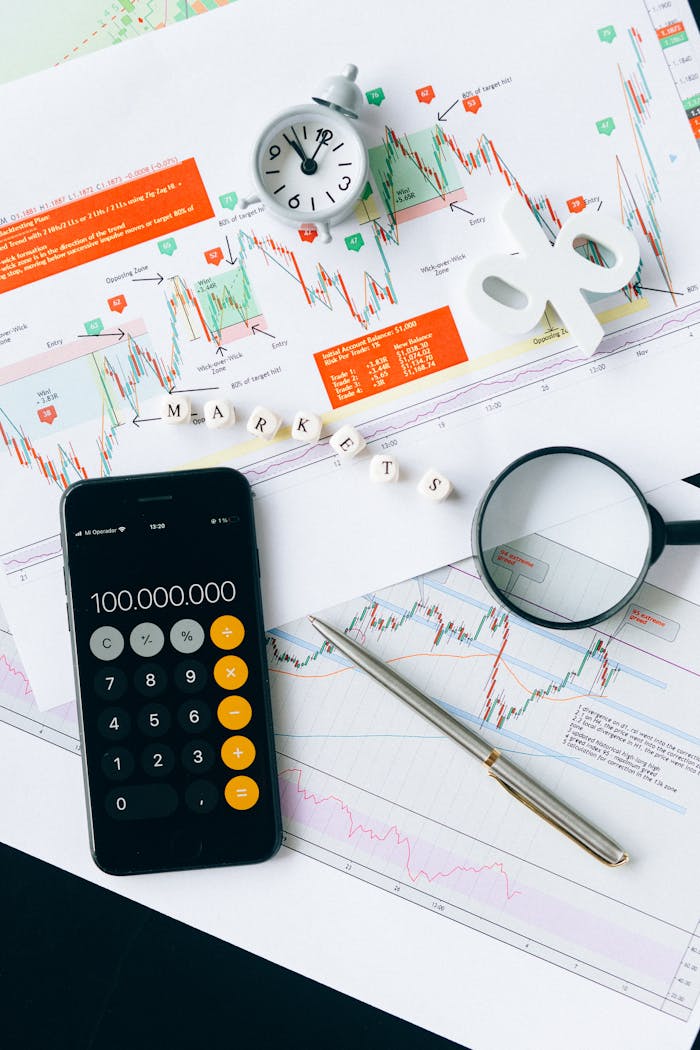 » pexels photo 6120182 Flat lay of charts, calculator, and magnifying glass on office desk for market analysis.
